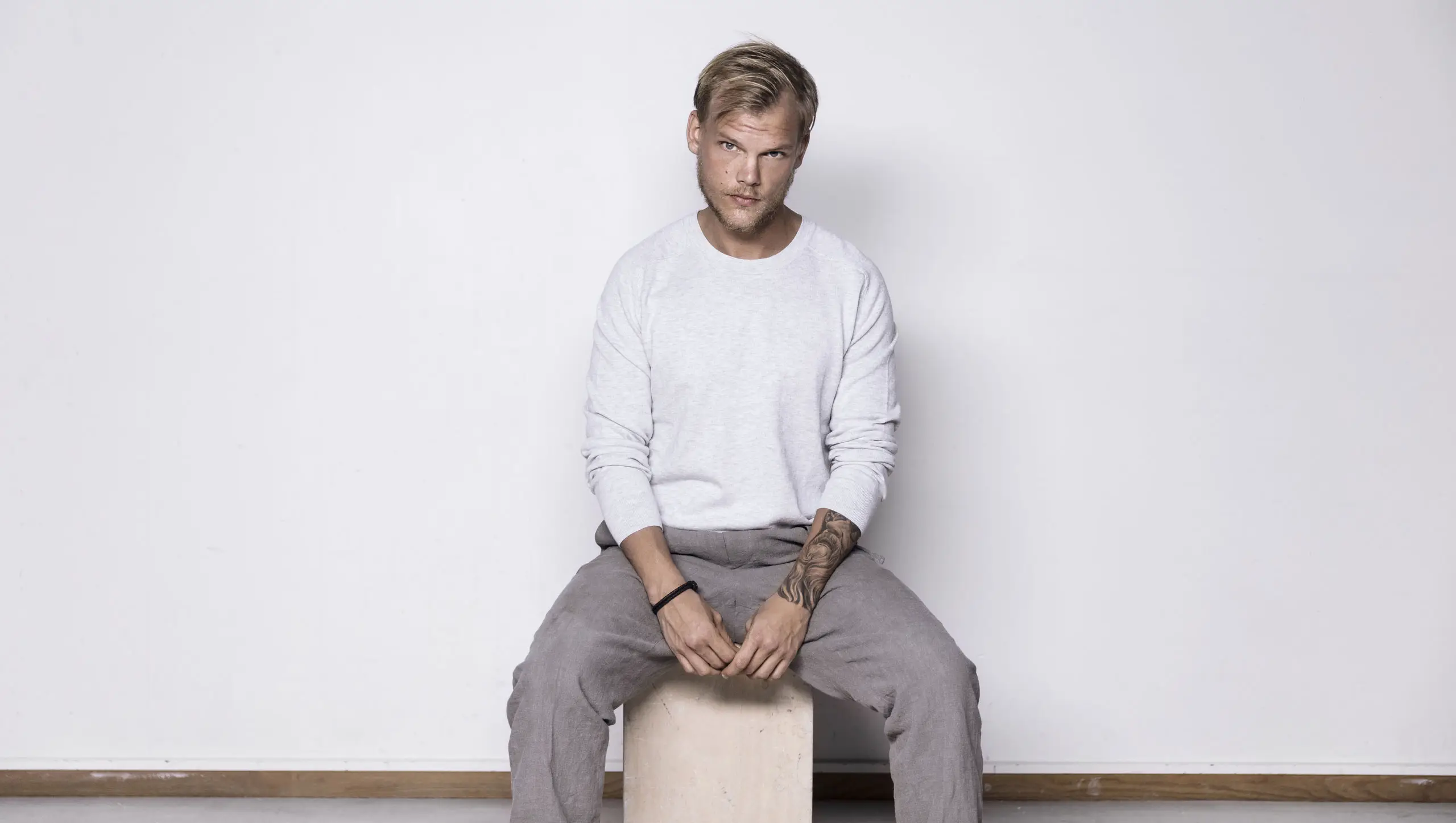 The Swedish DJ Avicii sitting and posted for a picture photographed by Sean Eriksson and Imani McCray